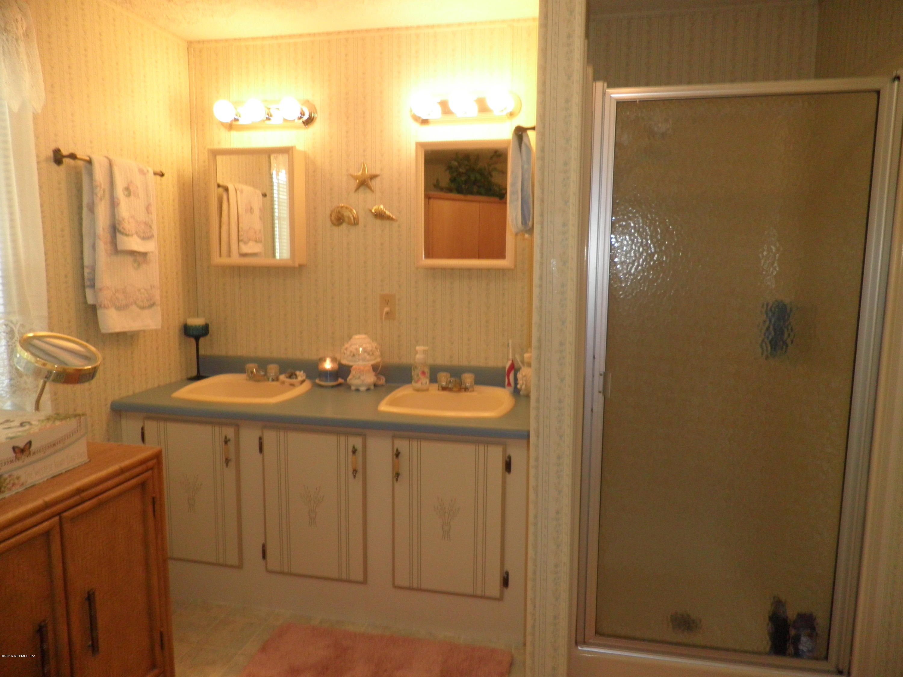 268 Beulah Church Road Welaka, FL 32112 - Photo 20 of 33 a bathroom with a sink a mirror and a shower