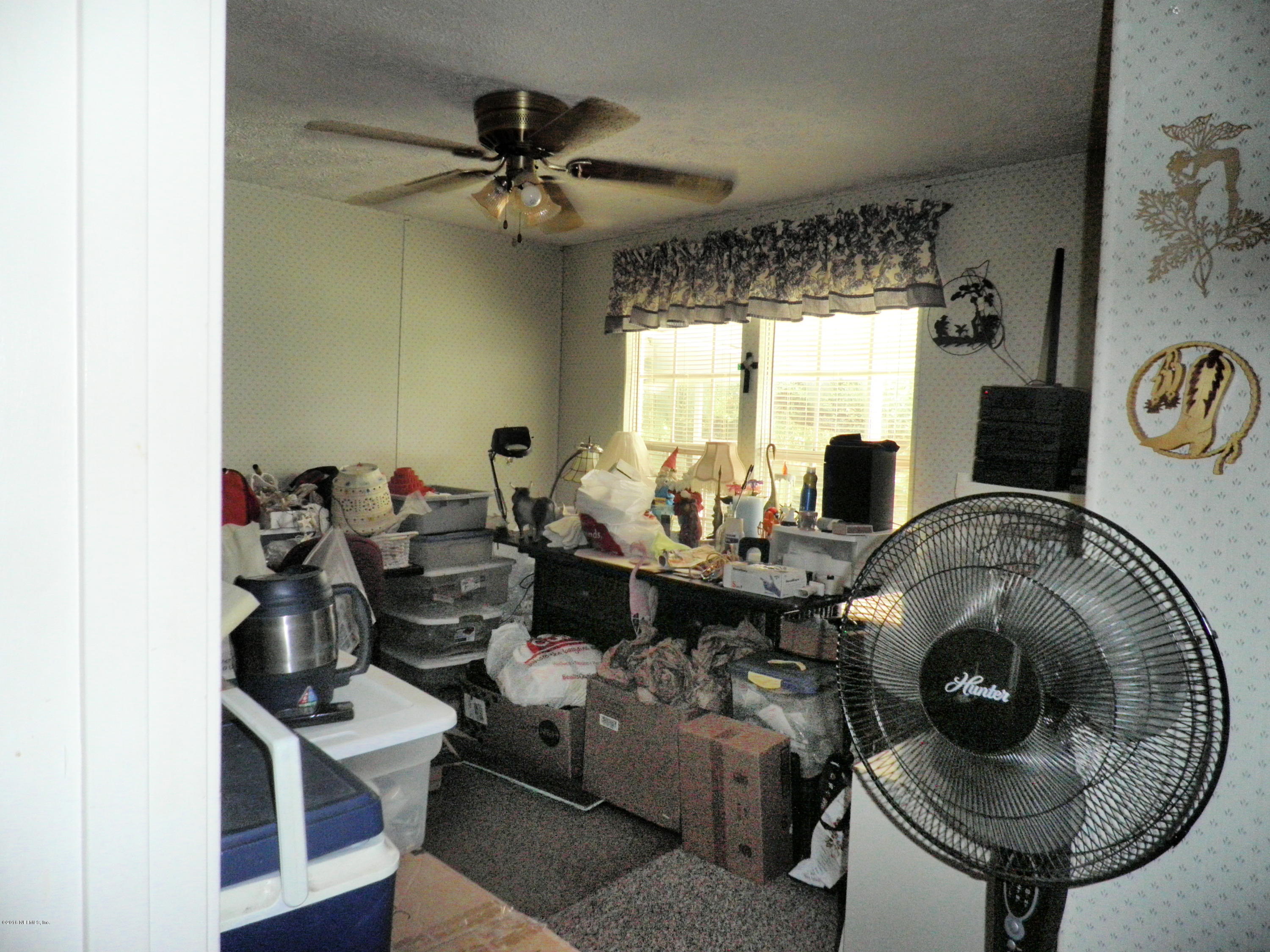 268 Beulah Church Road Welaka, FL 32112 - Photo 25 of 33 a living room with furniture and a large window