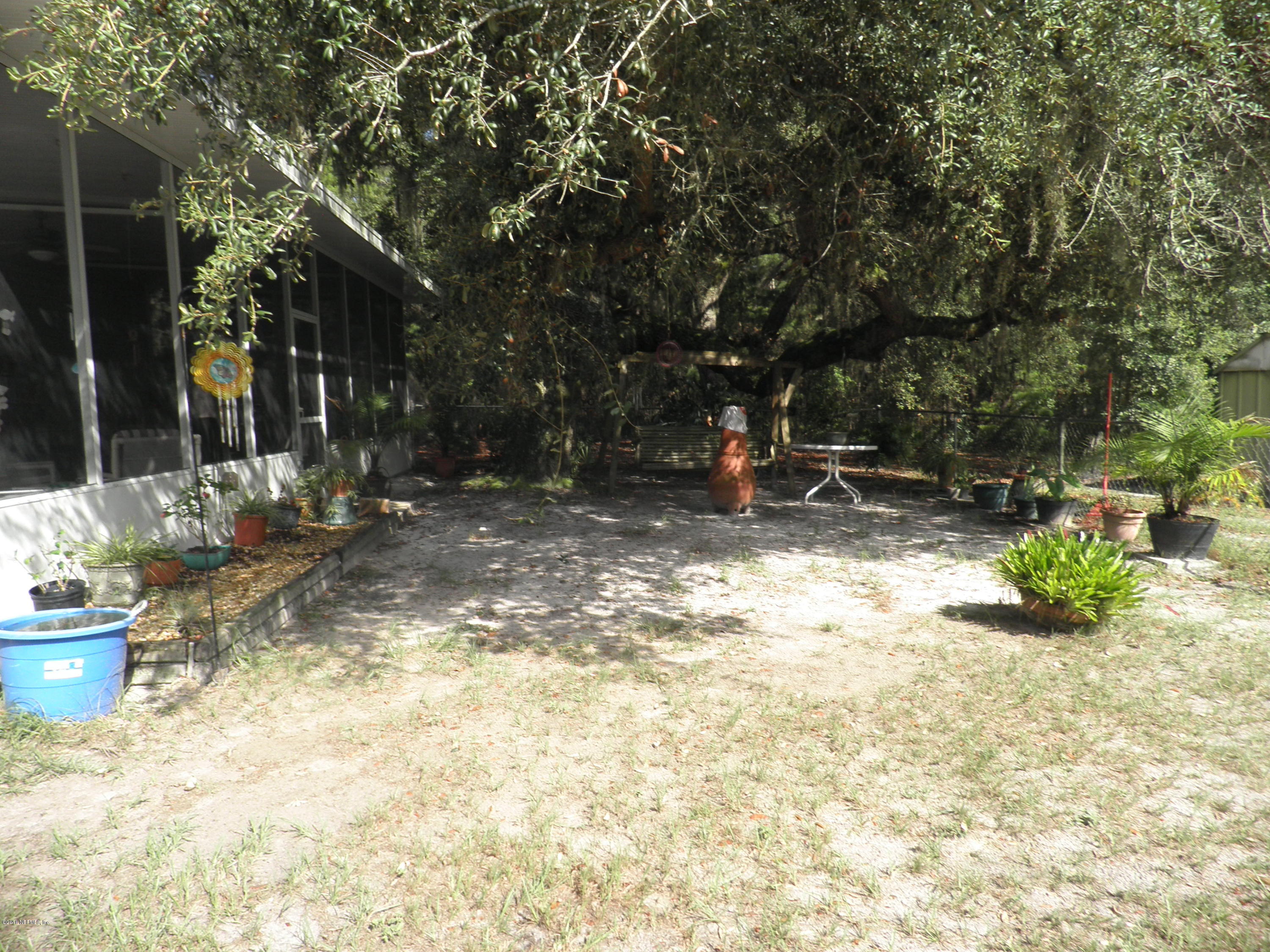 268 Beulah Church Road Welaka, FL 32112 - Photo 30 of 33 a view of backyard of house with outdoor seating and covered with green space