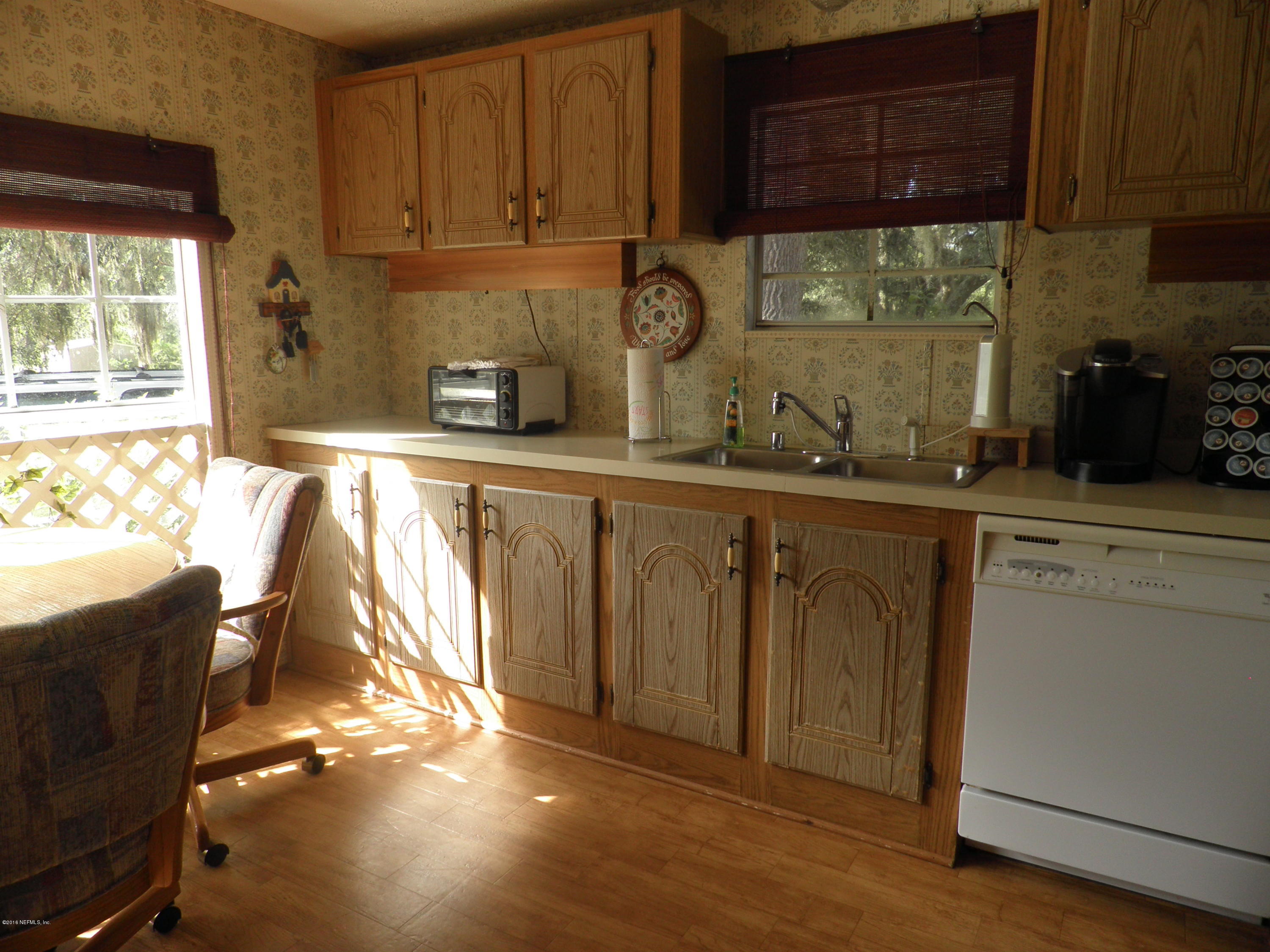 268 Beulah Church Road Welaka, FL 32112 - Photo 3 of 33 a kitchen with stainless steel appliances granite countertop a sink a stove and cabinets