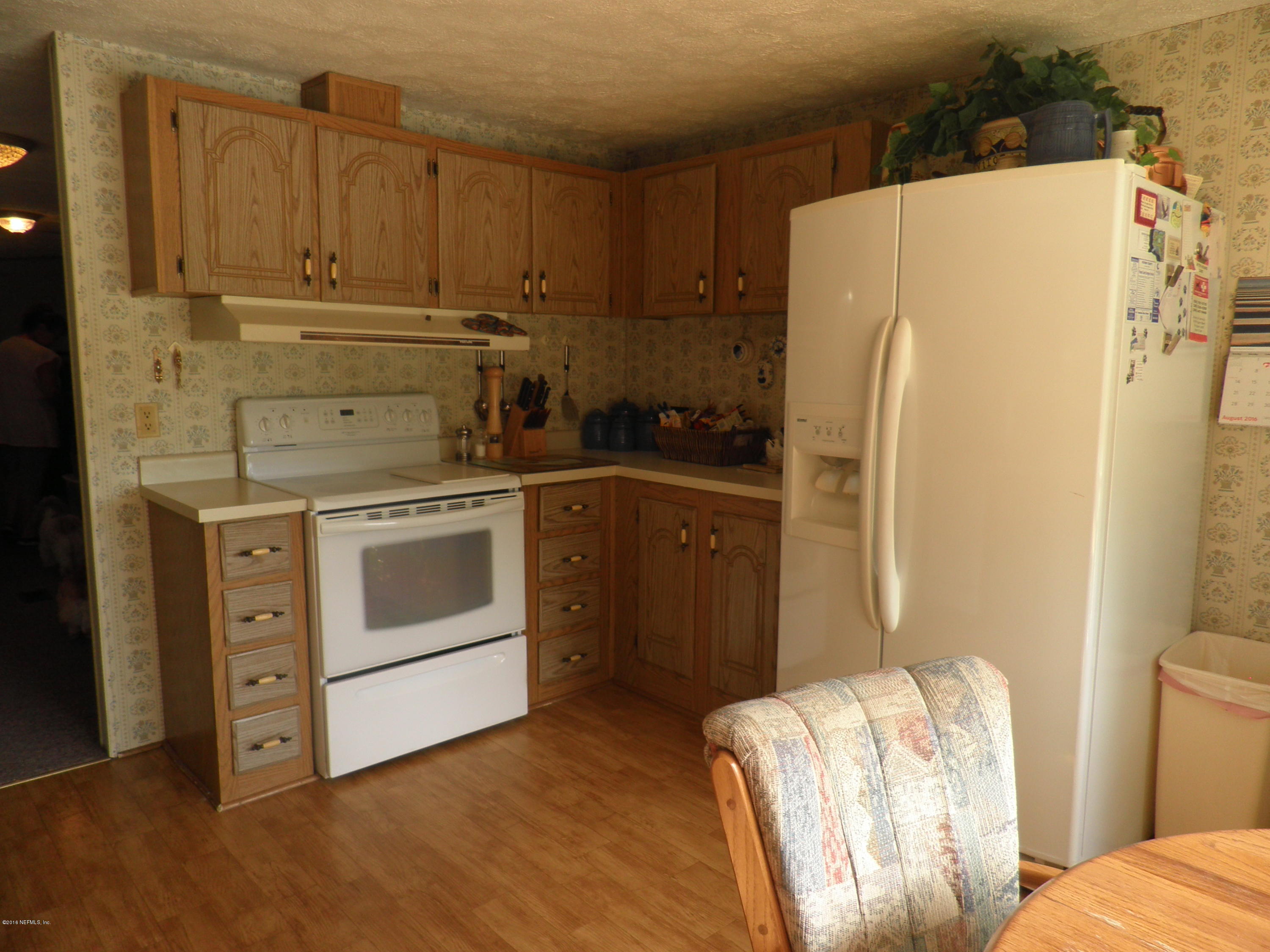 268 Beulah Church Road Welaka, FL 32112 - Photo 4 of 33 a kitchen with a white stove refrigerator and cabinets