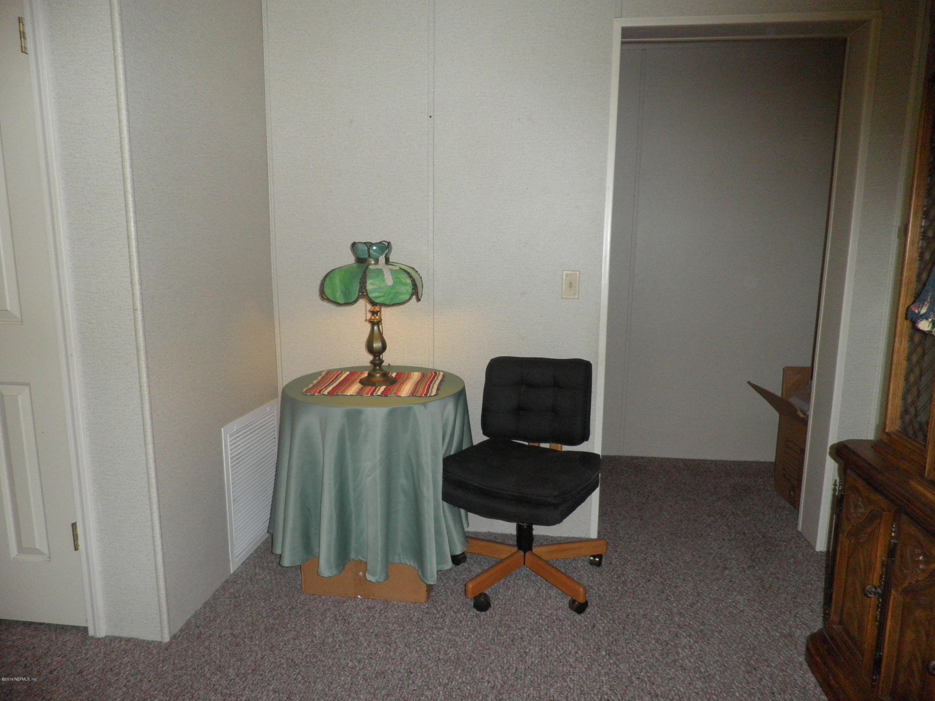 268 Beulah Church Road Welaka, FL 32112 - Photo 8 of 33 a living room with furniture and a window