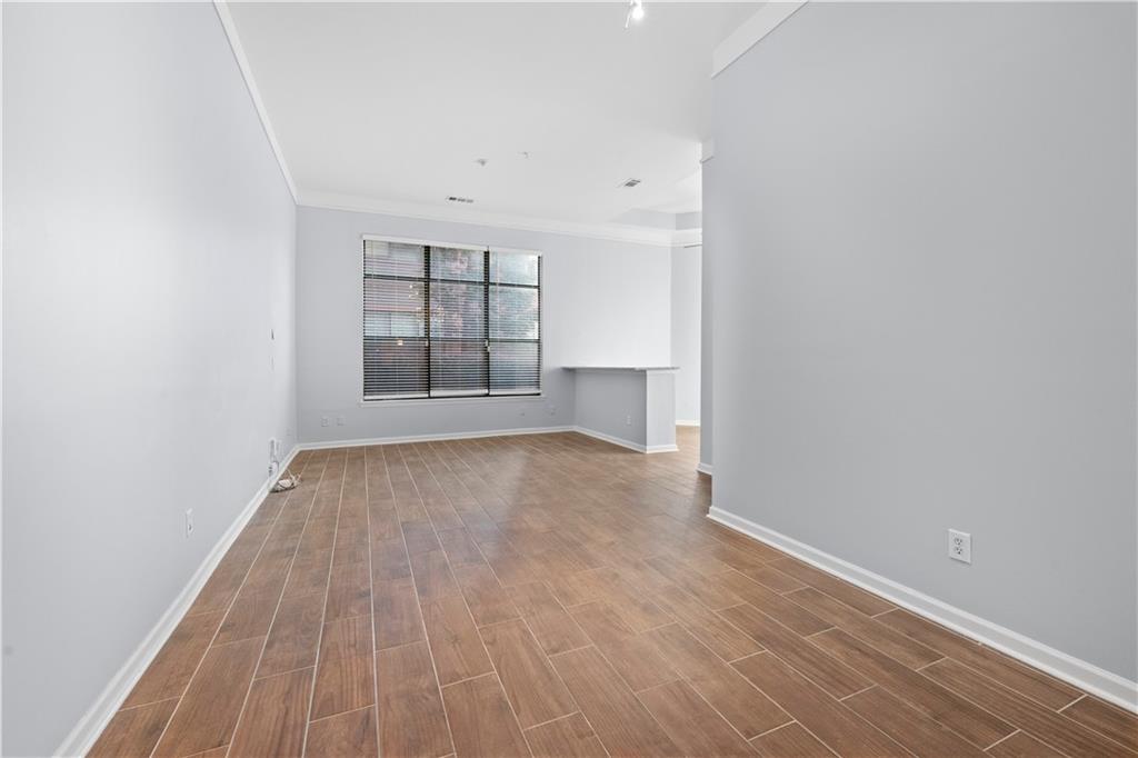 400 17th Street Northwest, Unit 1113 Atlanta, GA 30363 - Photo 12 of 37 wooden floor in an empty room with a window