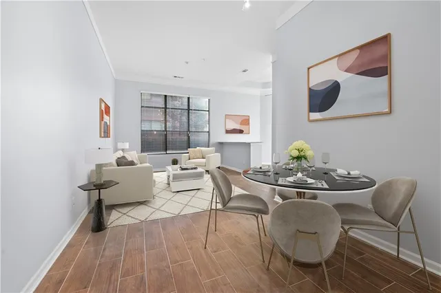 a view of a big room with wooden floor and windows