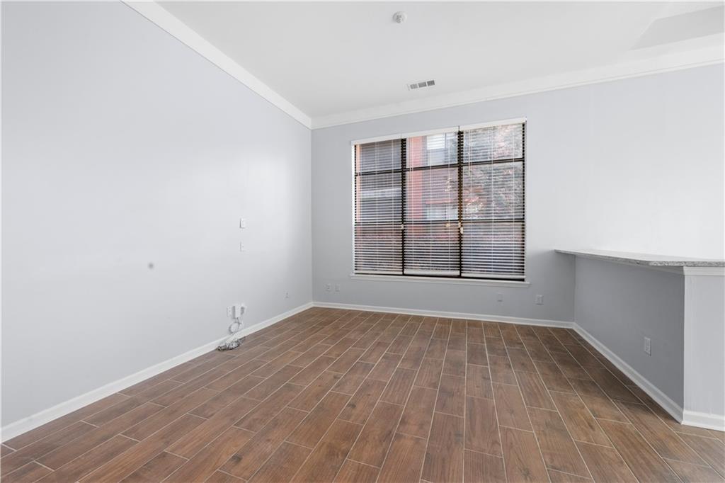 400 17th Street Northwest, Unit 1113 Atlanta, GA 30363 - Photo 26 of 37 an empty room with wooden floor and windows