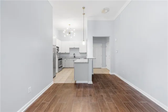 a view of a refrigerator in kitchen and wooden floor