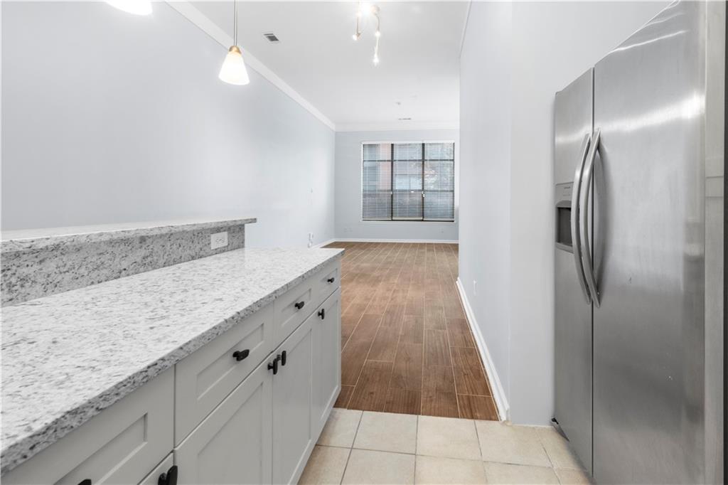 400 17th Street Northwest, Unit 1113 Atlanta, GA 30363 - Photo 28 of 37 a view of a refrigerator in kitchen and wooden floor