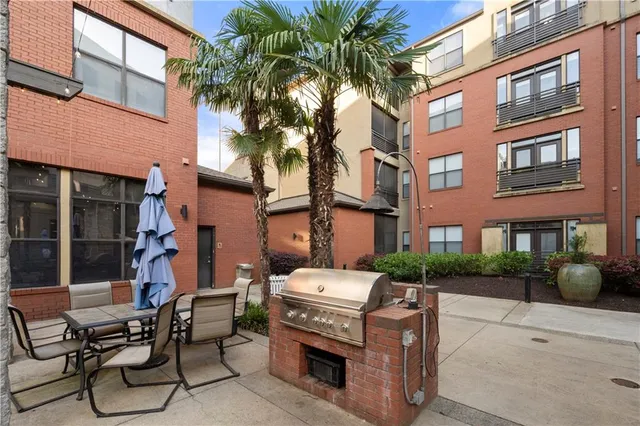 a living room with furniture a large window with kitchen view