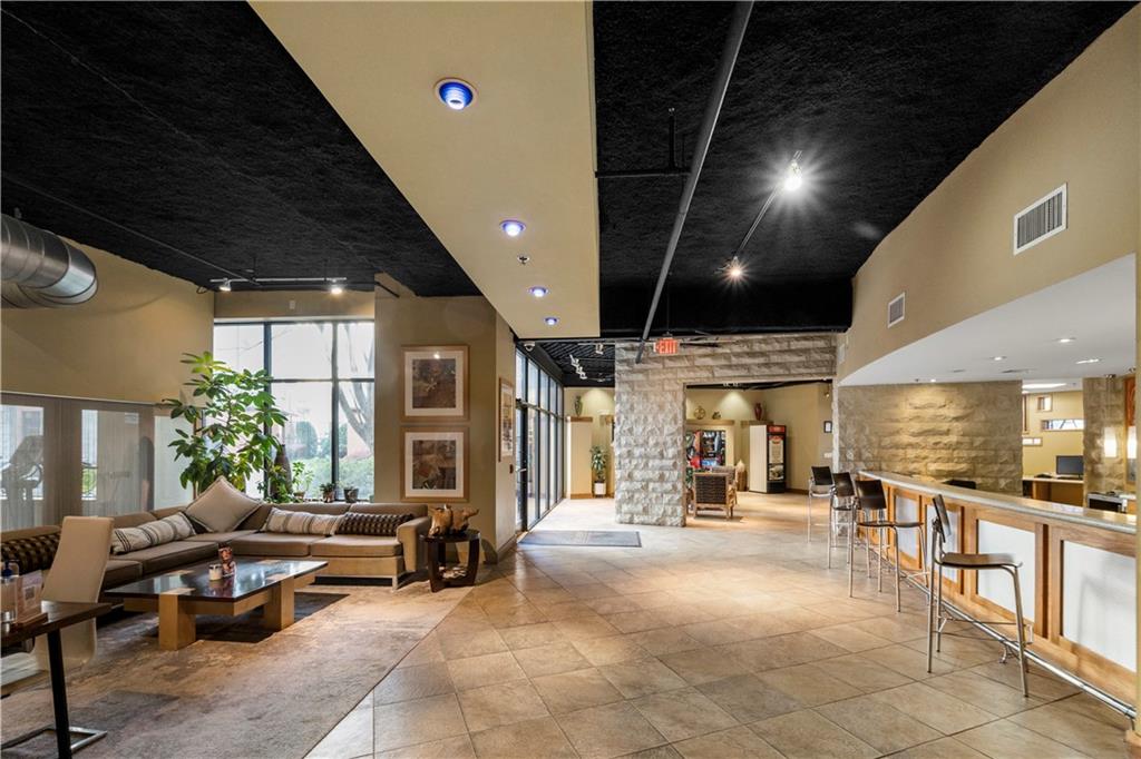 400 17th Street Northwest, Unit 1113 Atlanta, GA 30363 - Photo 36 of 37 a living room with furniture a large window with kitchen view