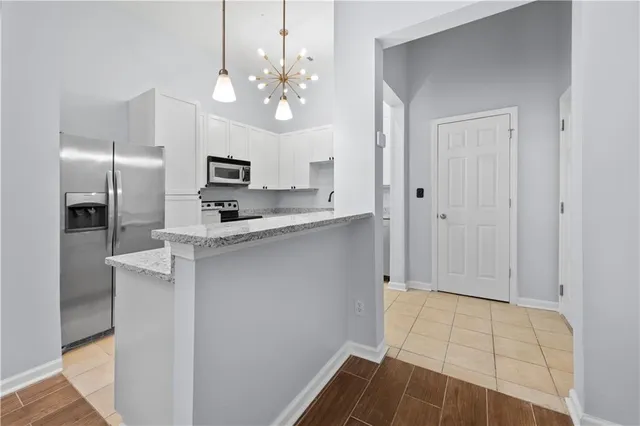 a kitchen with granite countertop a sink stove and refrigerator