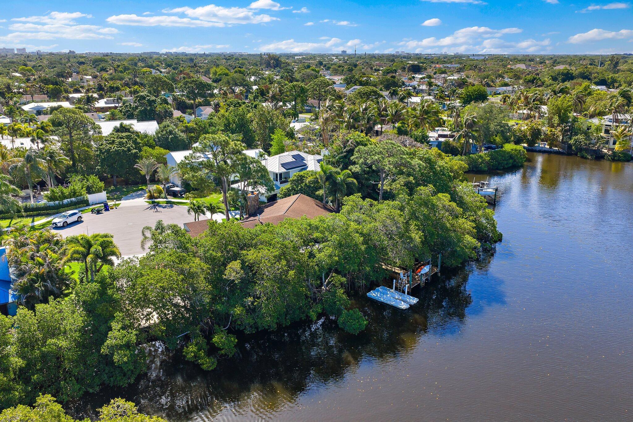 702 Warren Drive Jupiter, FL 33458 - Photo 7 of 76 an aerial view of a houses with a yard and lake view