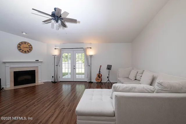 a living room with furniture and wooden floor