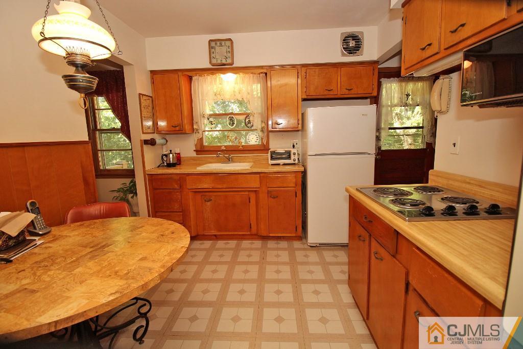 9 Gales Road Edison, NJ 08837 - Photo 14 of 25 a kitchen with a refrigerator a stove and a sink