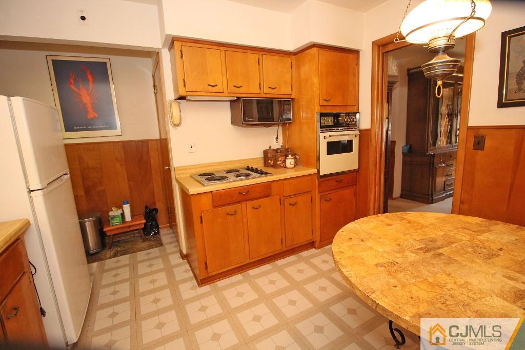 9 Gales Road Edison, NJ 08837 - Photo 17 of 25 a kitchen with stainless steel appliances a stove a refrigerator and cabinets