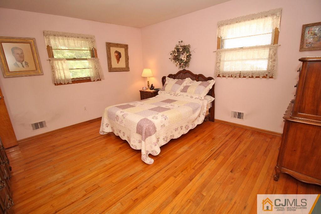 9 Gales Road Edison, NJ 08837 - Photo 19 of 25 a bedroom with a bed and wooden floor