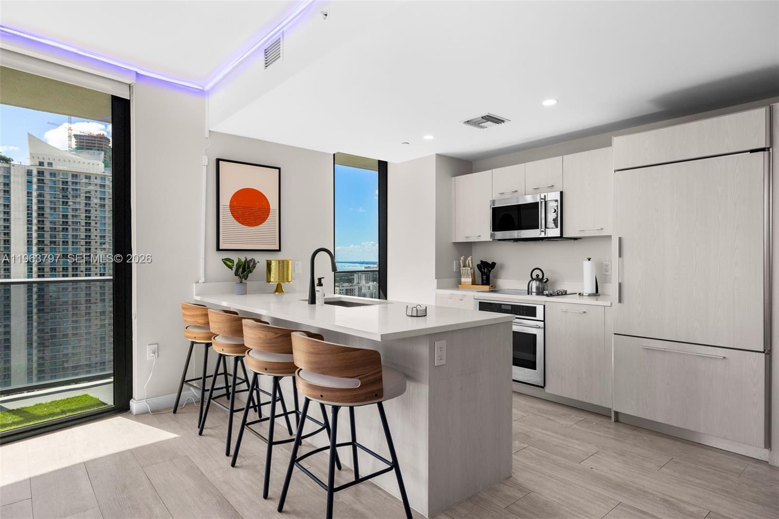 45 Southwest 9th Street, Unit 2803 Miami, FL 33130 - Photo 11 of 66 a kitchen with a sink appliances and cabinets