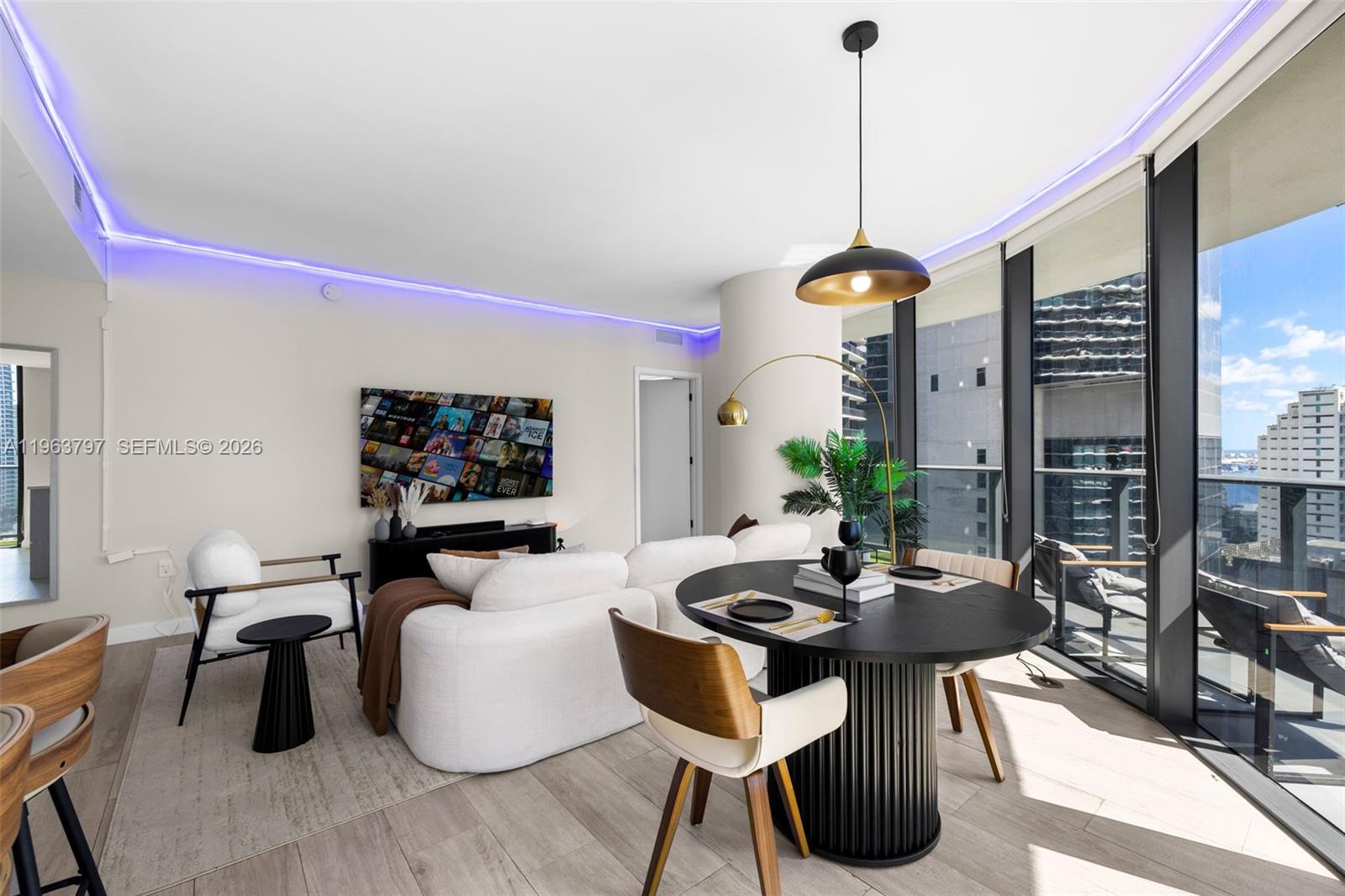 45 Southwest 9th Street, Unit 2803 Miami, FL 33130 - Photo 15 of 66 a living room with furniture and a window