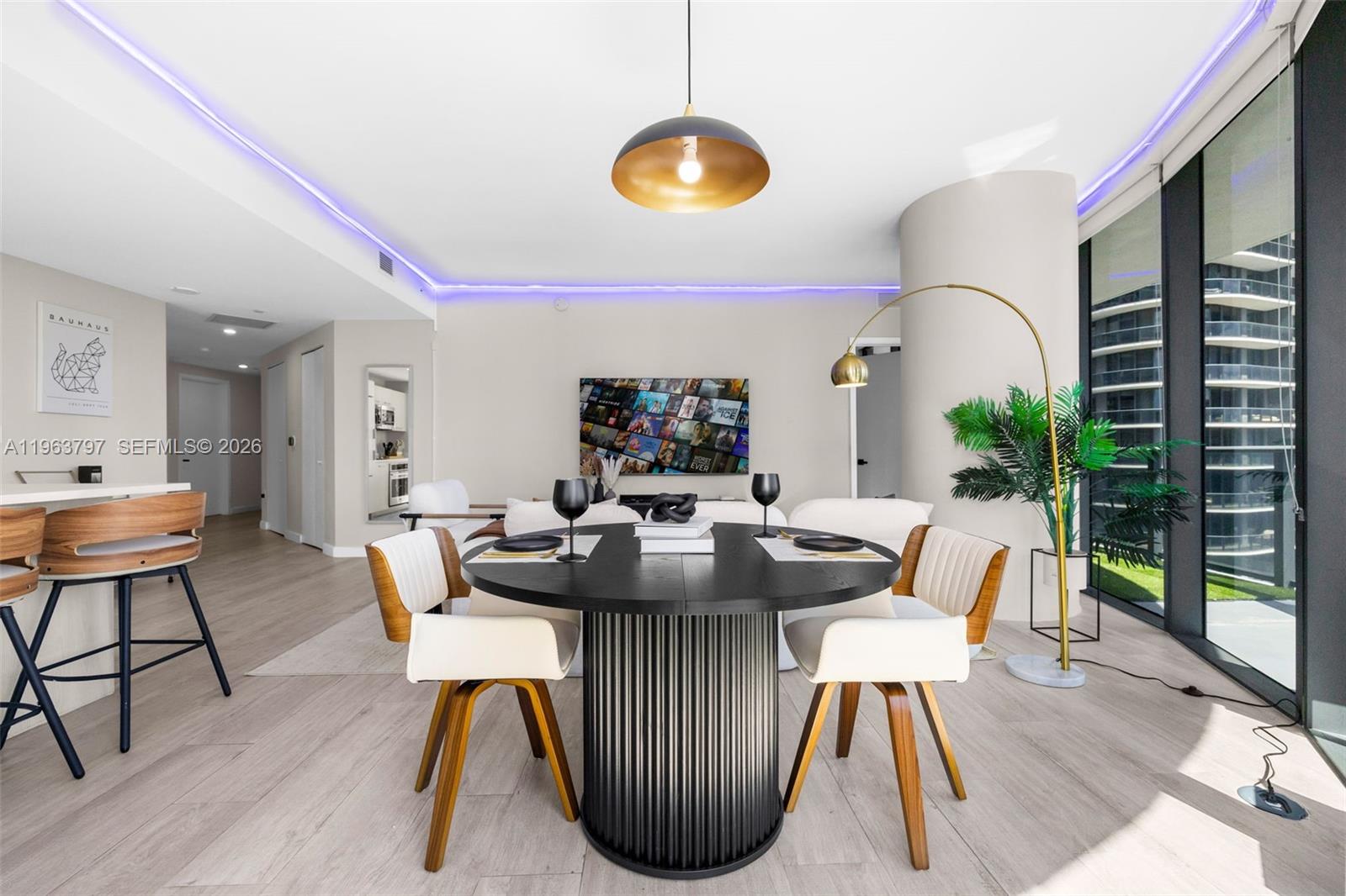 45 Southwest 9th Street, Unit 2803 Miami, FL 33130 - Photo 17 of 66 a dining room with furniture garden view and a chandelier