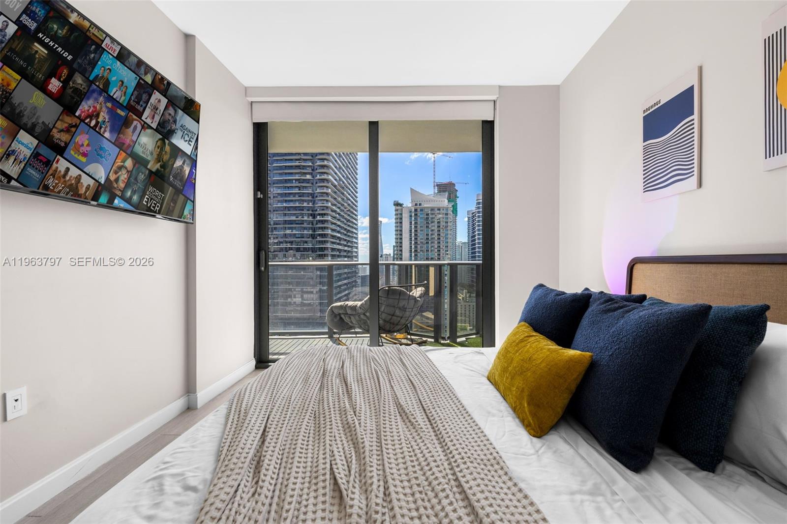 45 Southwest 9th Street, Unit 2803 Miami, FL 33130 - Photo 29 of 66 a bedroom with a bed and wooden floor