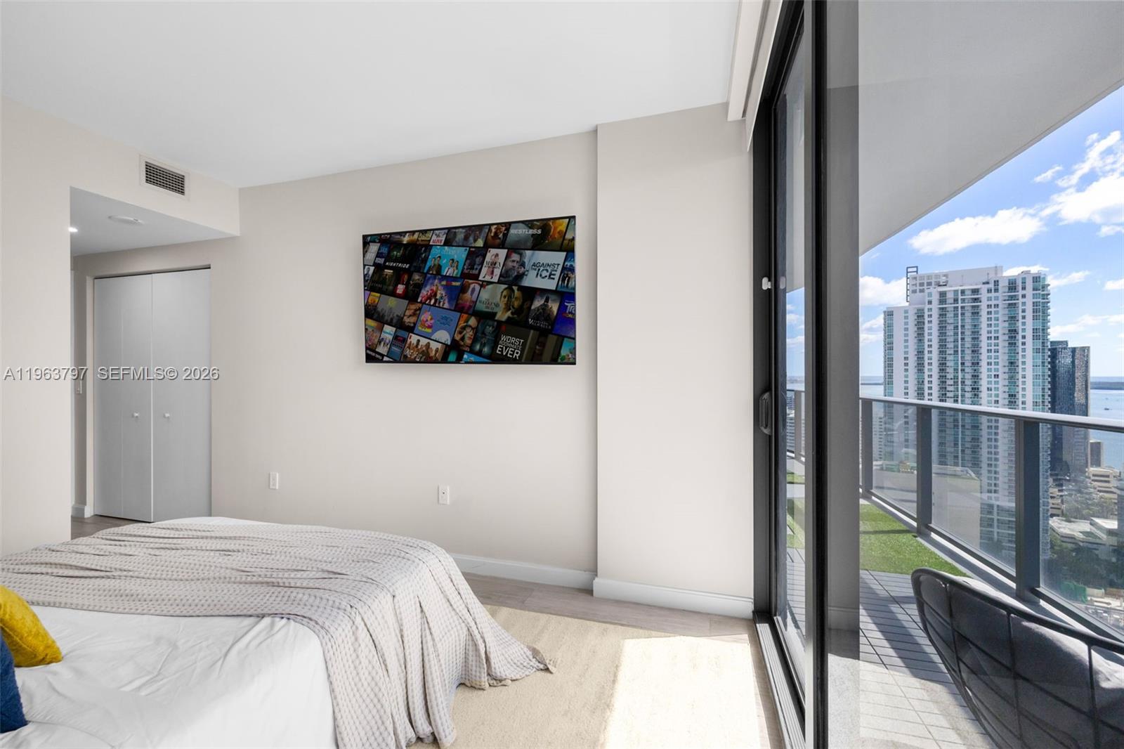 45 Southwest 9th Street, Unit 2803 Miami, FL 33130 - Photo 31 of 66 a bedroom with a bed and a painting on the wall