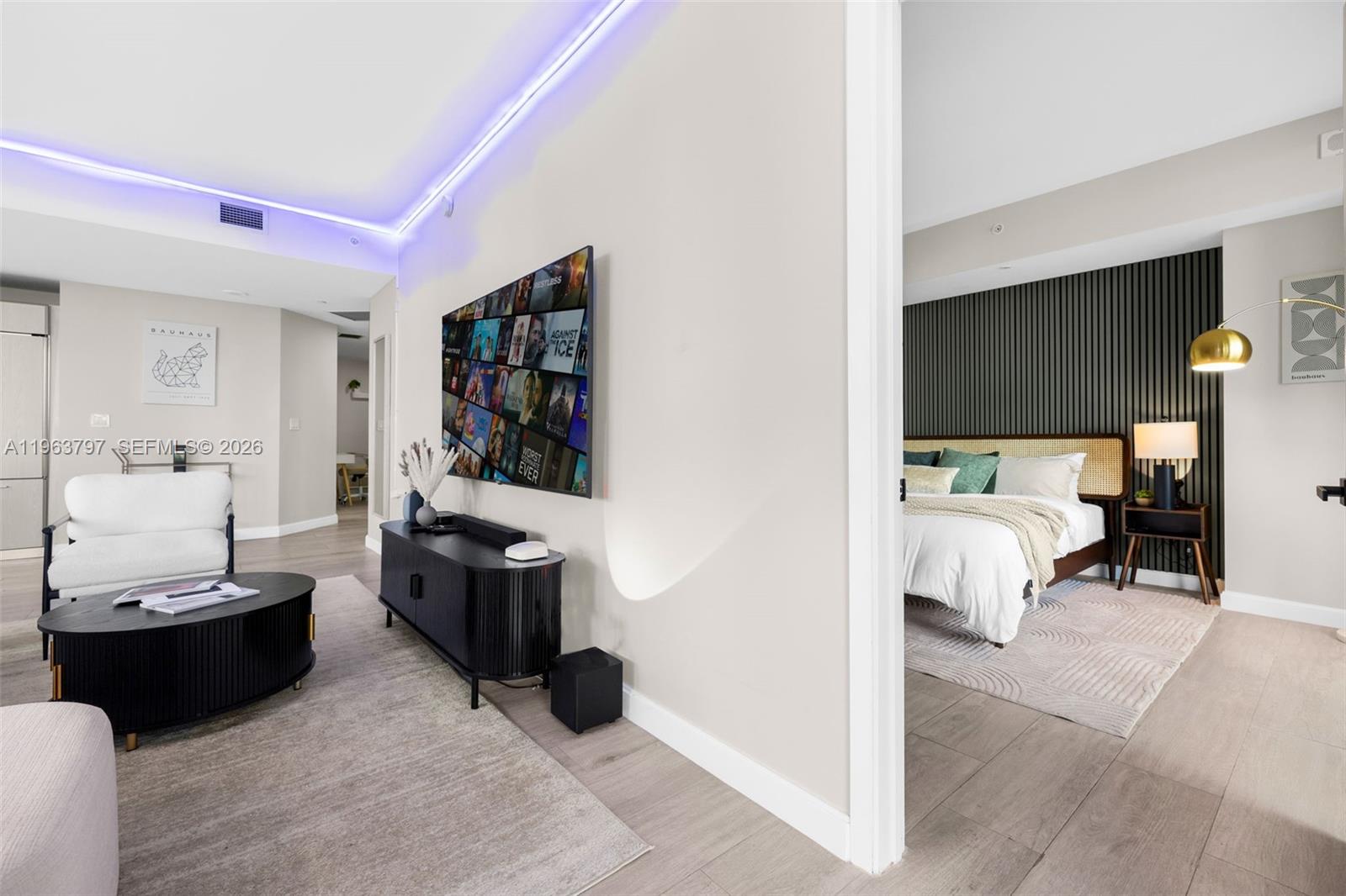 45 Southwest 9th Street, Unit 2803 Miami, FL 33130 - Photo 32 of 66 a living room with furniture and a flat screen tv