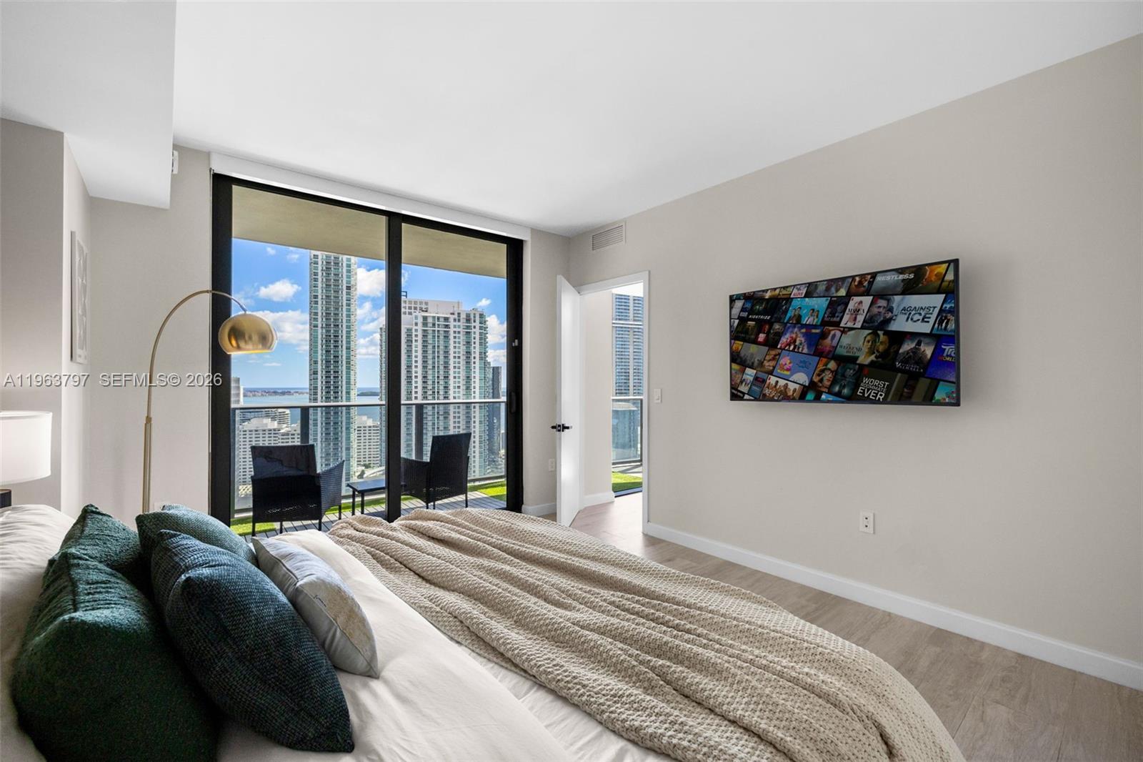 45 Southwest 9th Street, Unit 2803 Miami, FL 33130 - Photo 35 of 66 a bedroom with a large bed and a large window