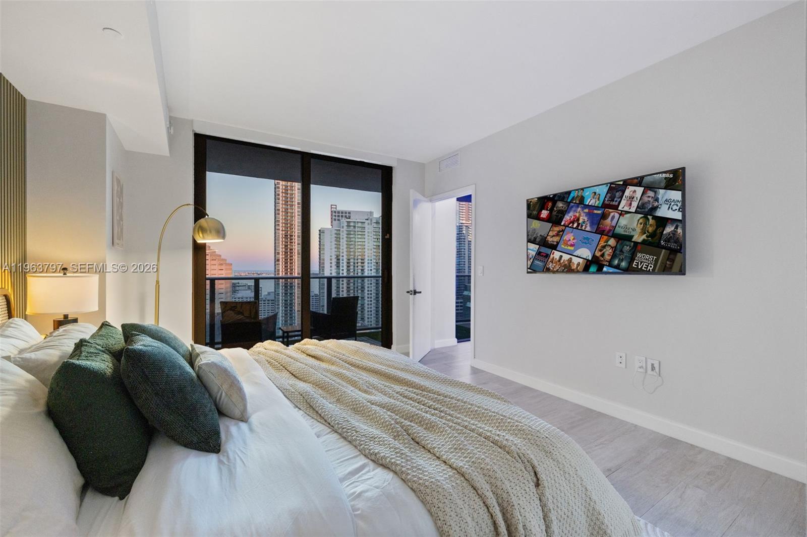 45 Southwest 9th Street, Unit 2803 Miami, FL 33130 - Photo 37 of 66 a bed sitting in a bedroom next to a window