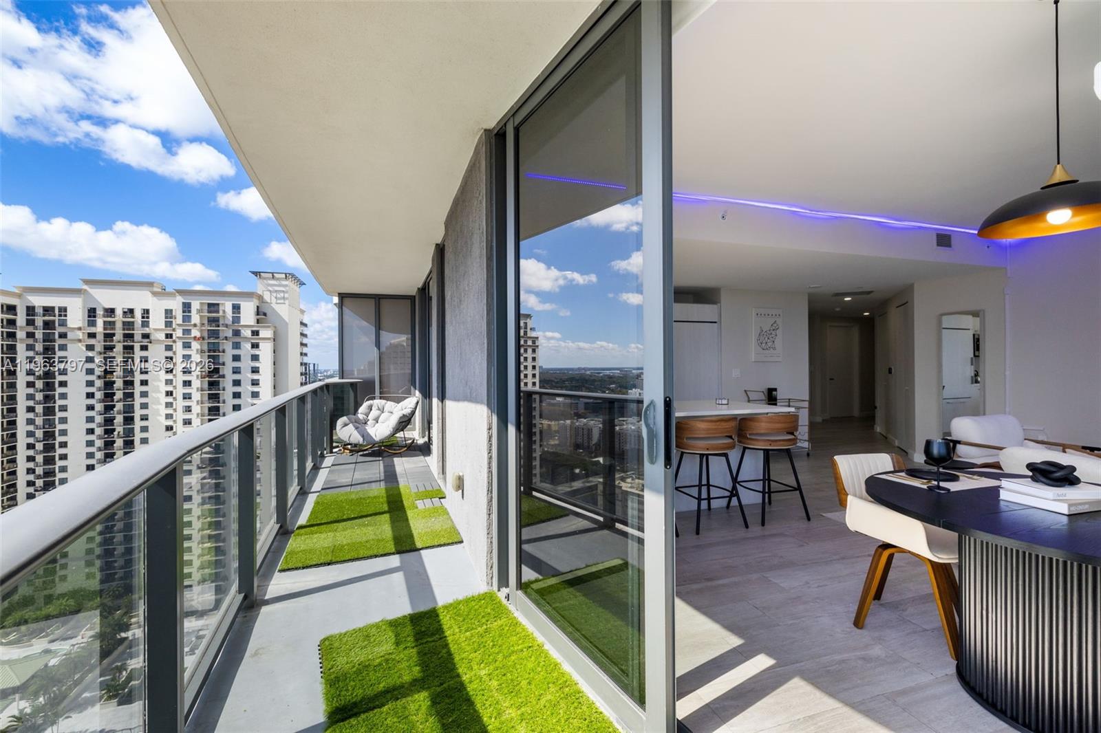 45 Southwest 9th Street, Unit 2803 Miami, FL 33130 - Photo 41 of 66 a view of an chairs and tables in the balcony