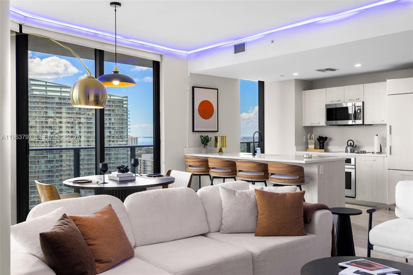 45 Southwest 9th Street, Unit 2803 Miami, FL 33130 - Photo 6 of 66 a living room with furniture and a chandelier