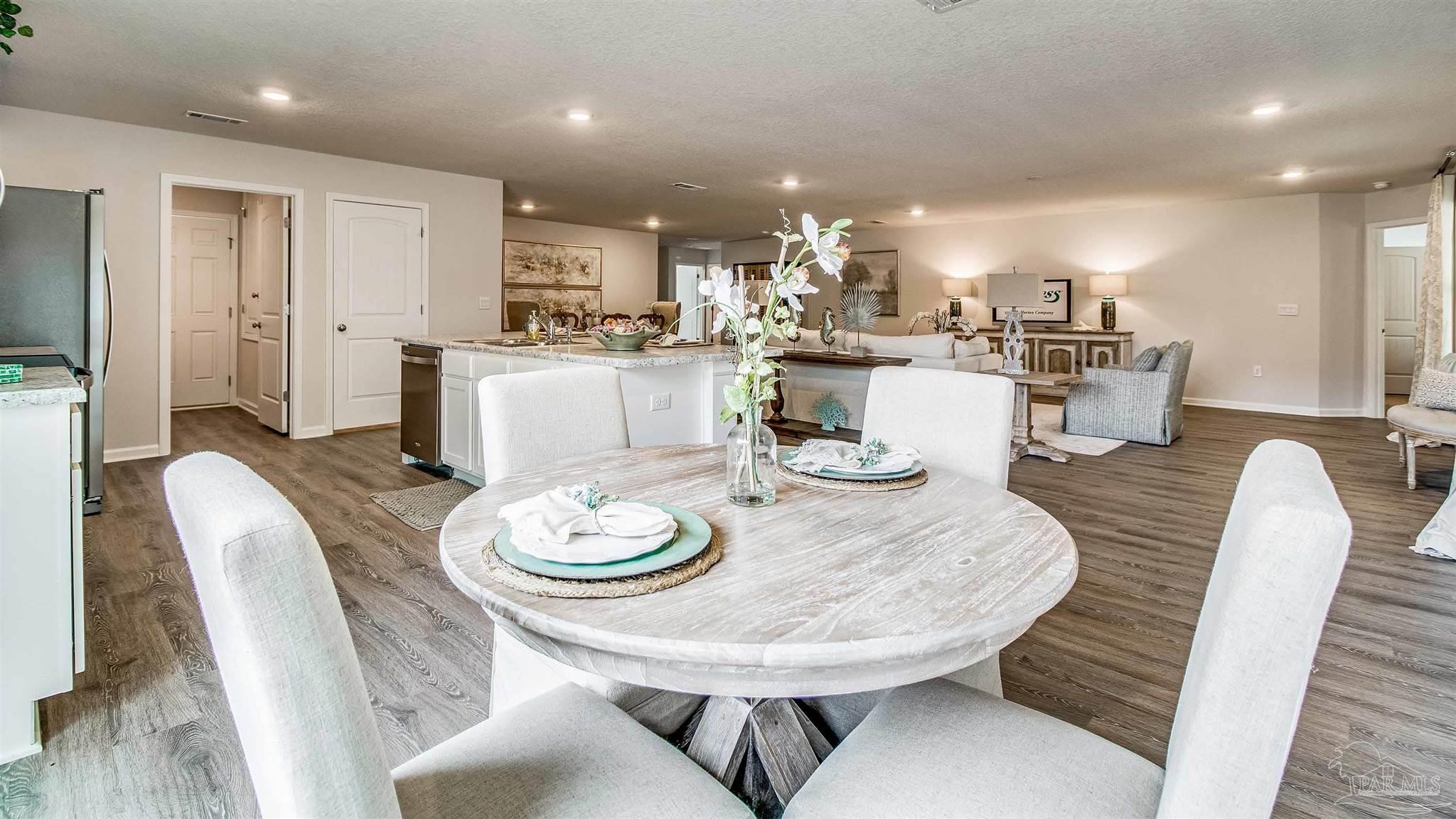 9728 Dutton Lane Milton, FL 32583 - Photo 11 of 31 a dining room with stainless steel appliances a table and chairs