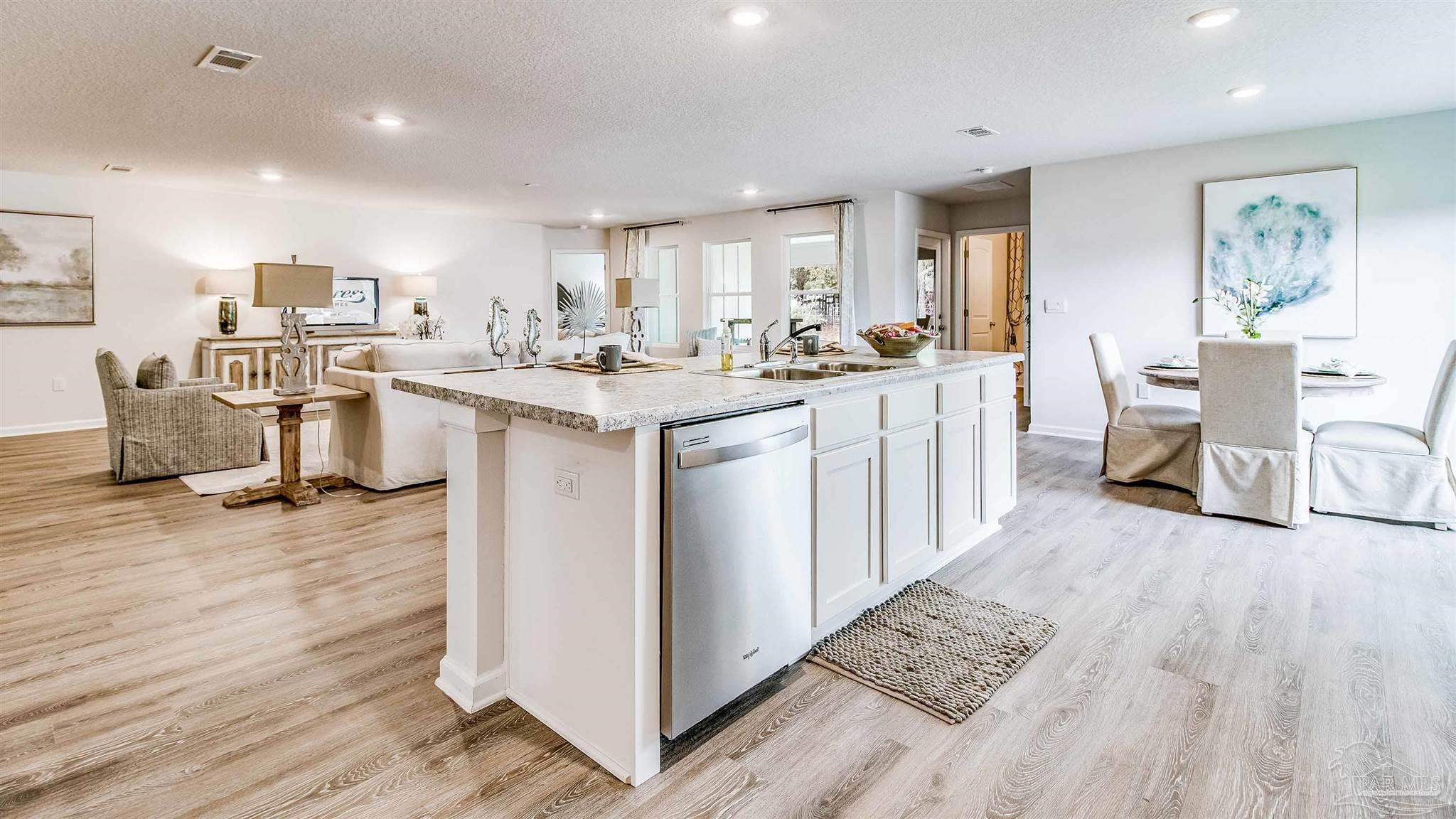 9728 Dutton Lane Milton, FL 32583 - Photo 12 of 31 a kitchen with a sink cabinets and wooden floor