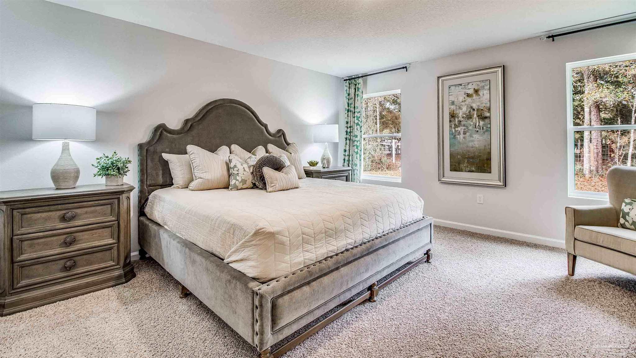 9728 Dutton Lane Milton, FL 32583 - Photo 23 of 31 a bedroom with a bed and a painting on the wall