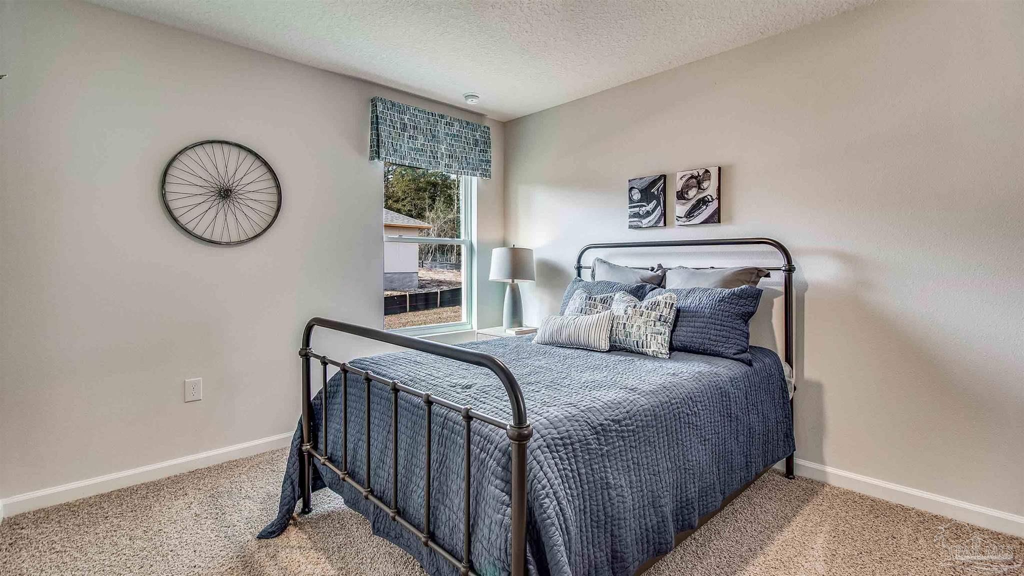 9728 Dutton Lane Milton, FL 32583 - Photo 28 of 31 a bedroom with a bed and window