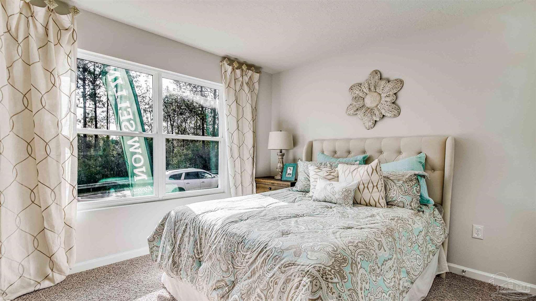 9728 Dutton Lane Milton, FL 32583 - Photo 30 of 31 a bedroom with a large bed and a large window