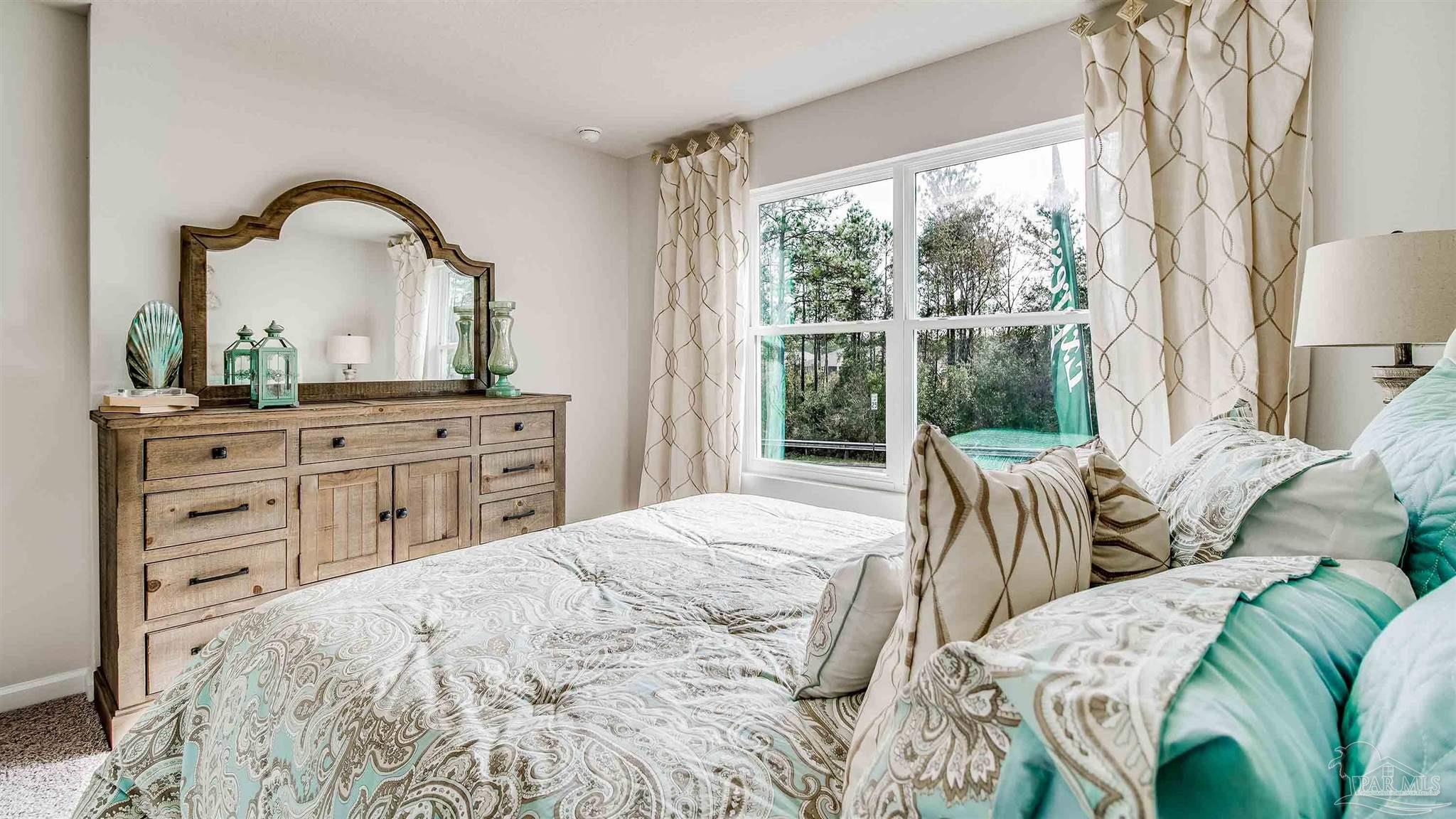 9728 Dutton Lane Milton, FL 32583 - Photo 31 of 31 a bedroom with a bed and a large window with outer view