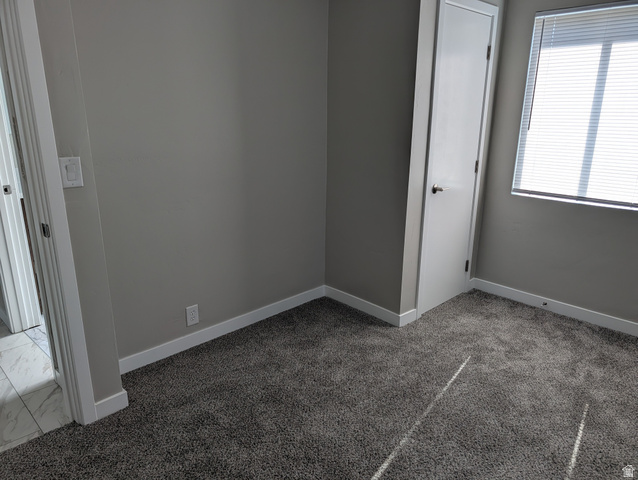2880 Merton Way Magna, UT 84044 - Photo 7 of 30 Carpeted interior room featuring neutral gray walls and white trim