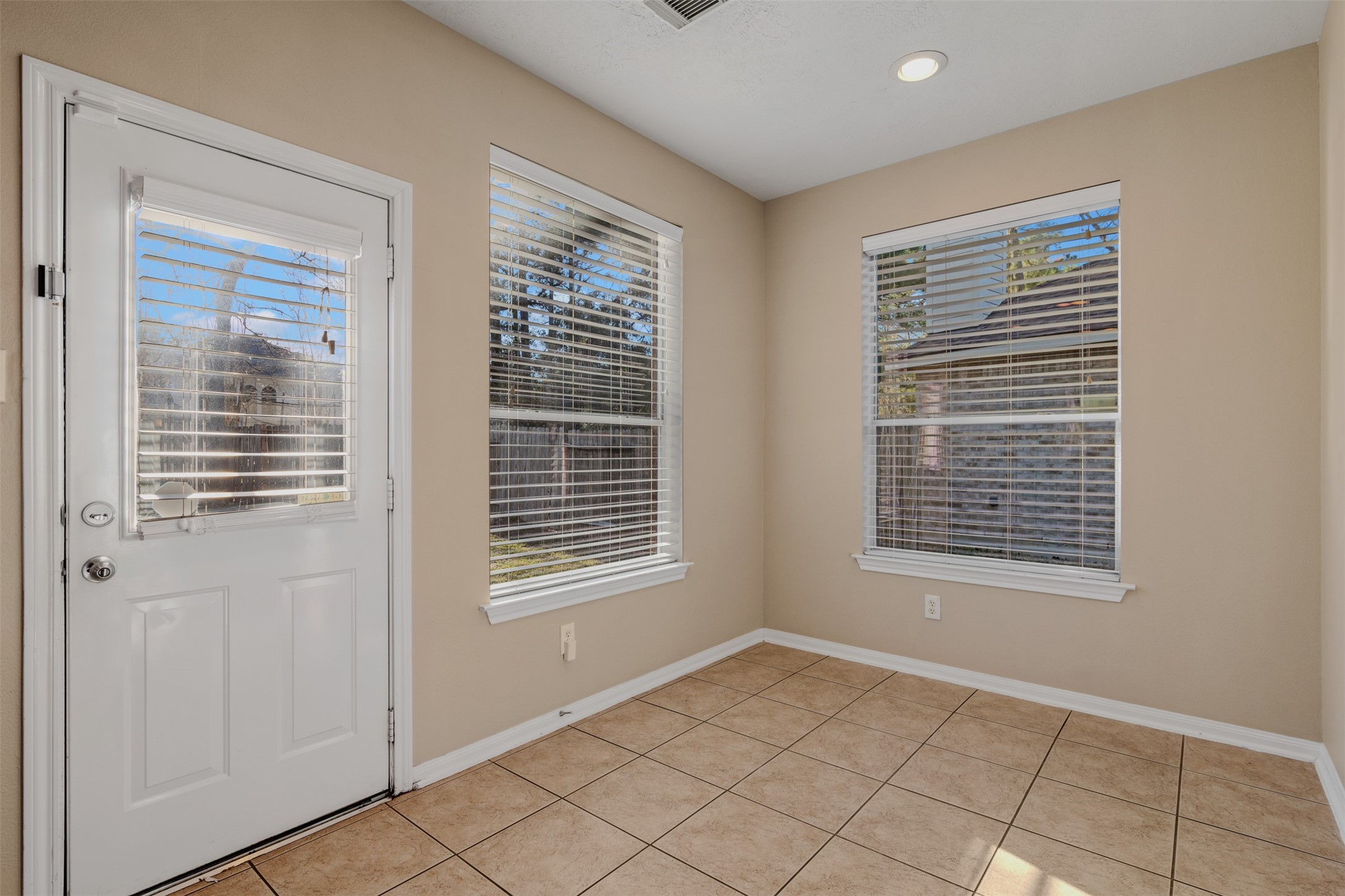 118 Bryce Branch Circle Spring, TX 77382 - Photo 11 of 25 a view of an empty room with window and a kitchen
