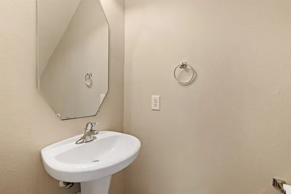 a bathroom with a sink and mirror
