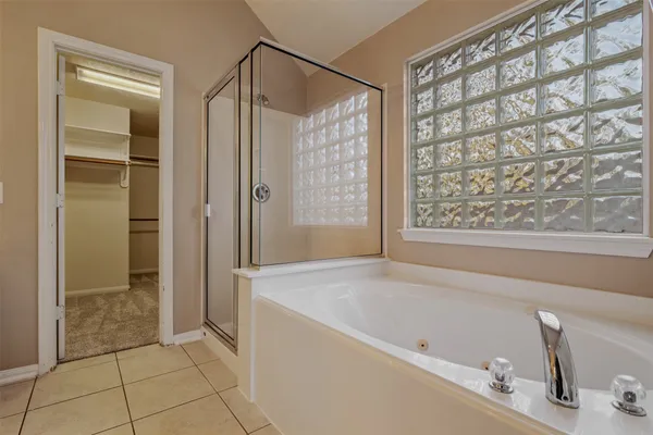 a bathroom with a tub and shower