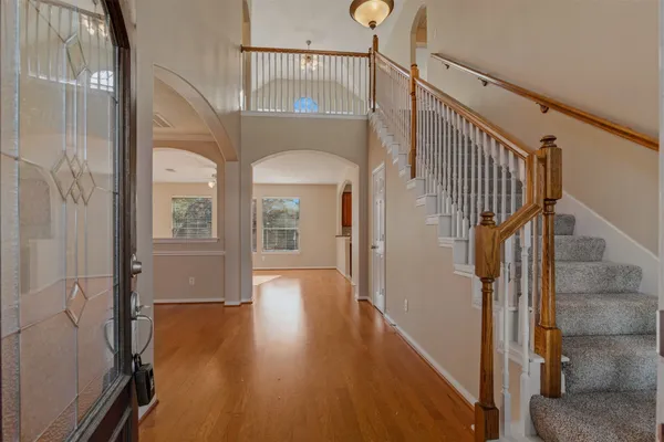 a view of entryway and hall with wooden floor