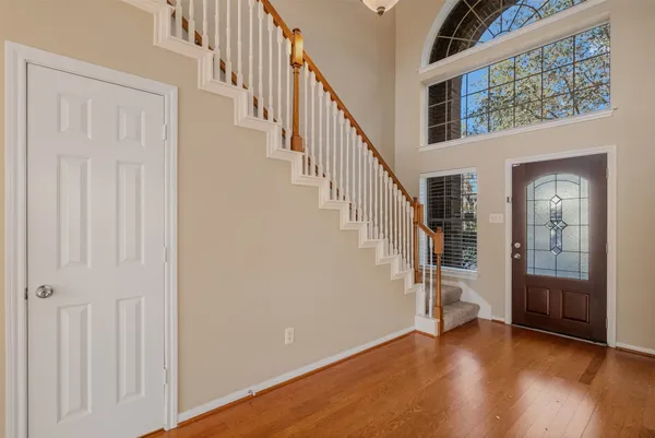 a view of an entryway with wooden floor and door