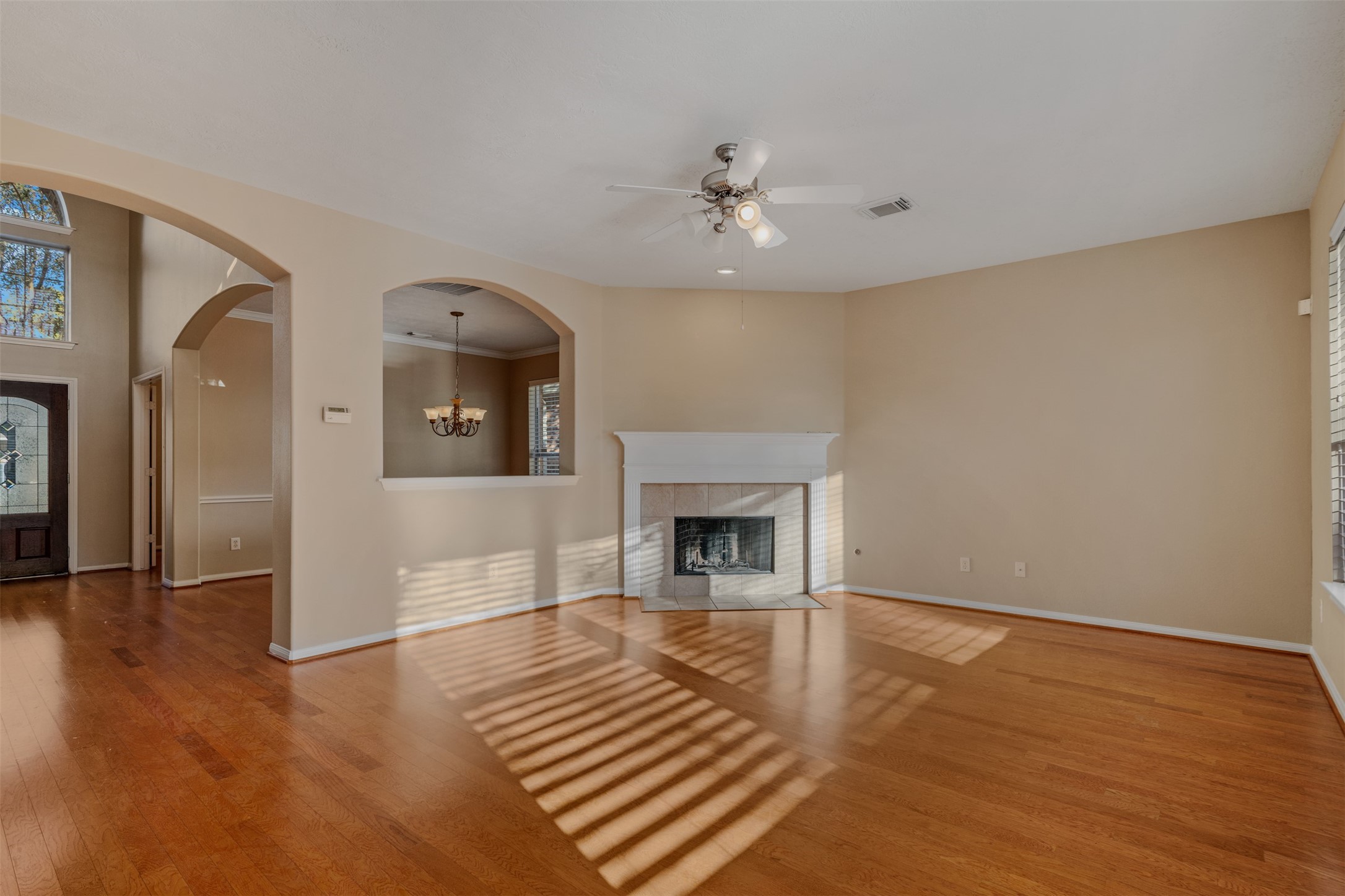 118 Bryce Branch Circle Spring, TX 77382 - Photo 8 of 25 wooden floor fireplace and windows in an empty room