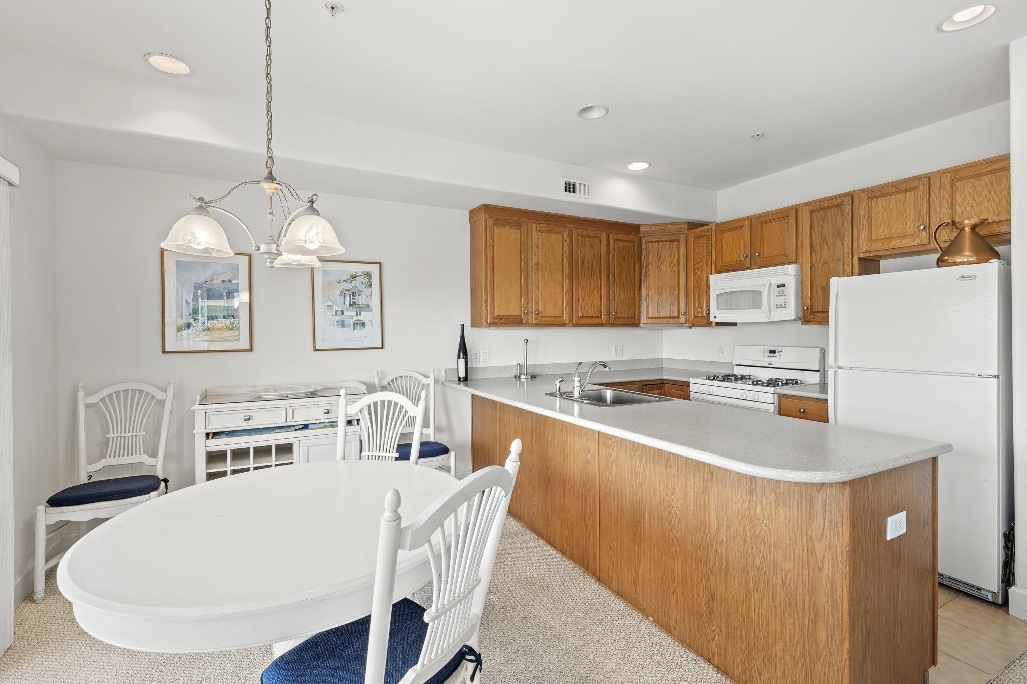 700 Ocean Drive, Unit E4 Avalon, NJ 08202 - Photo 14 of 31 a kitchen with kitchen island a stove a sink a center island and a refrigerator