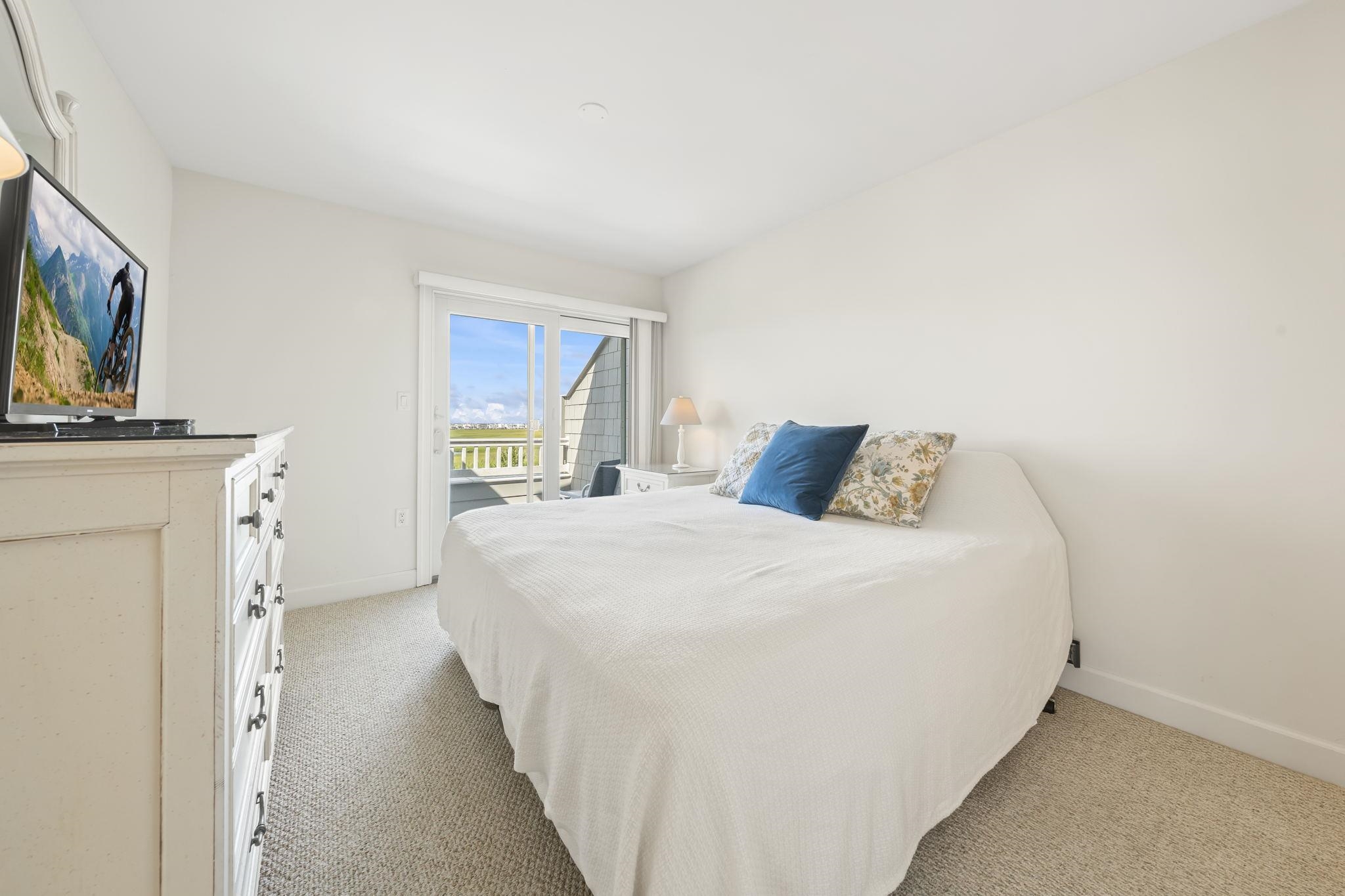 700 Ocean Drive, Unit E4 Avalon, NJ 08202 - Photo 22 of 31 a bedroom with a bed and a flat screen tv