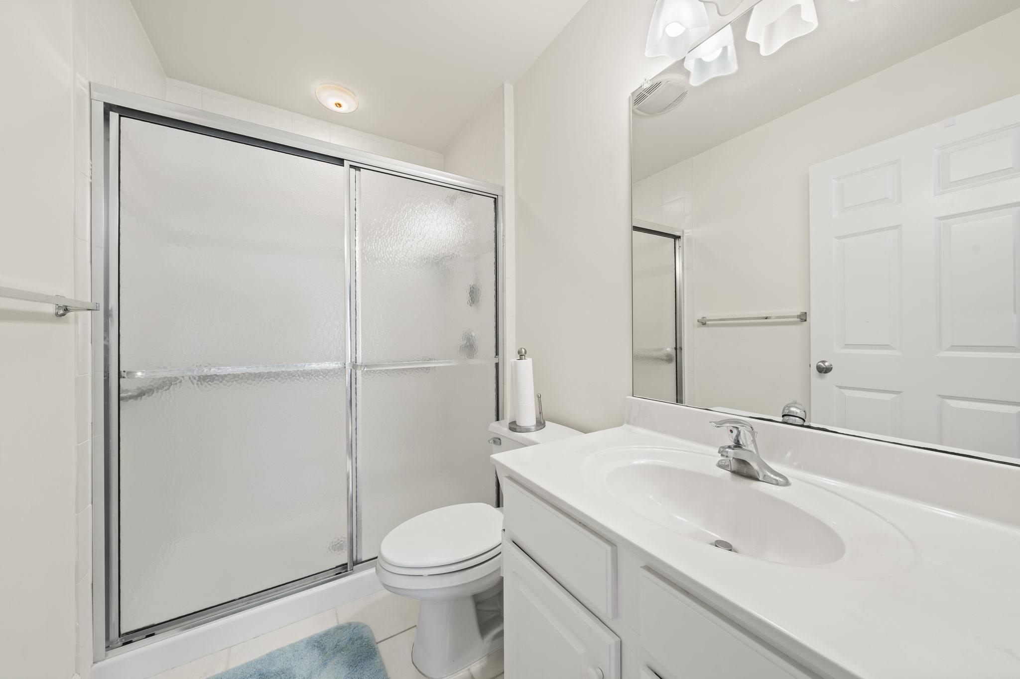 700 Ocean Drive, Unit E4 Avalon, NJ 08202 - Photo 26 of 31 a bathroom with a sink toilet and shower