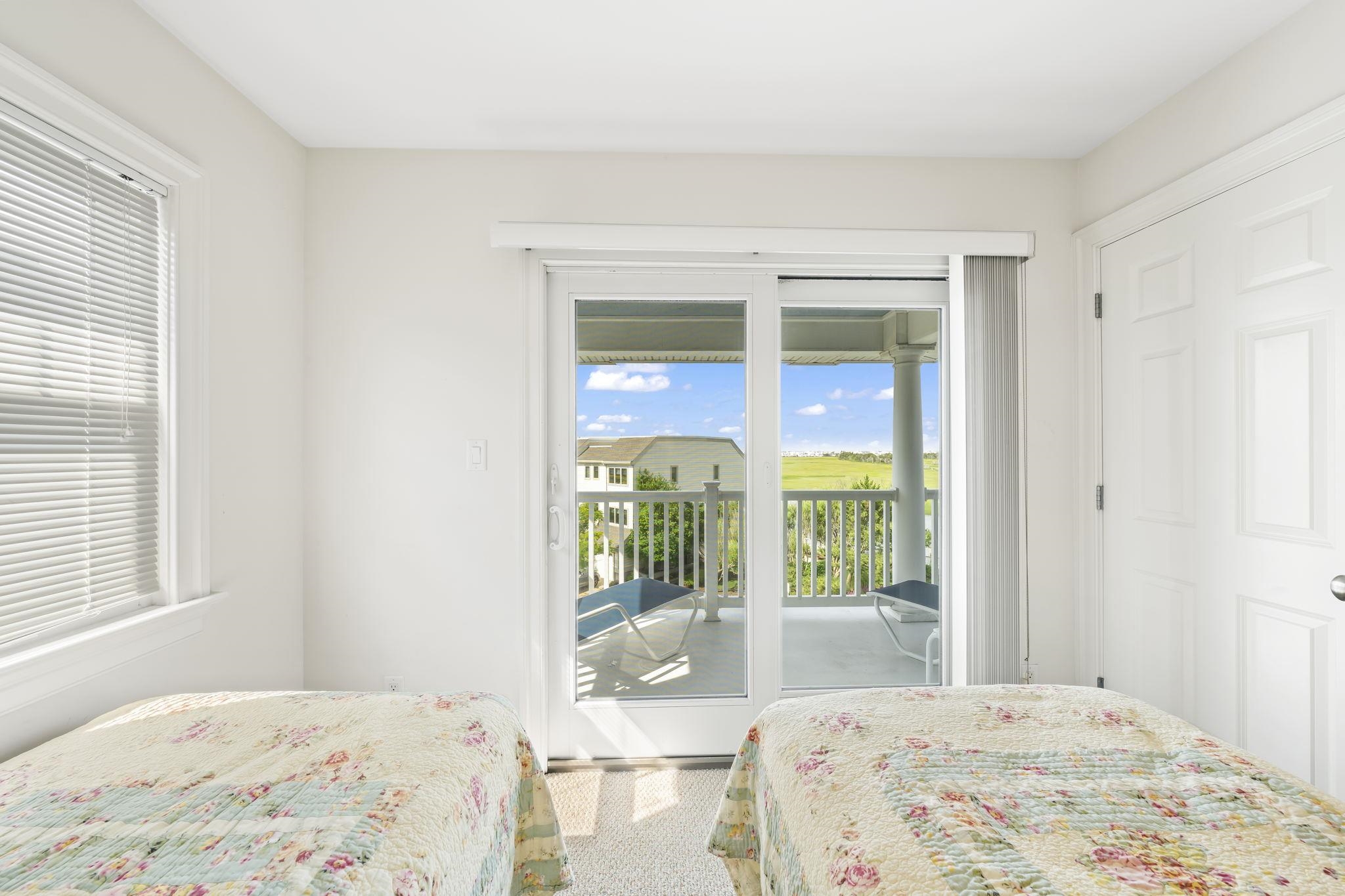 700 Ocean Drive, Unit E4 Avalon, NJ 08202 - Photo 27 of 31 a bedroom with a bed and glass door