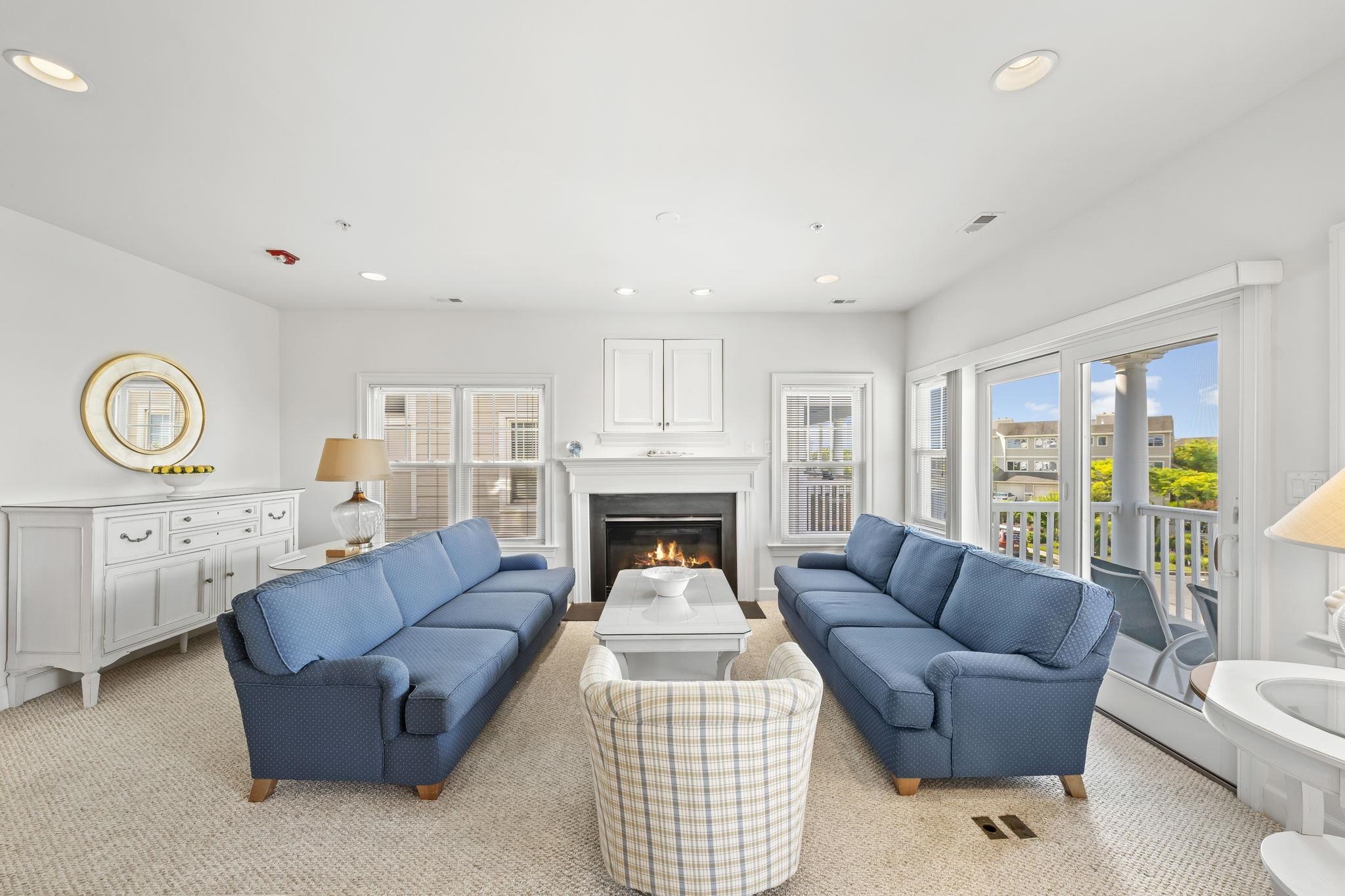 700 Ocean Drive, Unit E4 Avalon, NJ 08202 - Photo 8 of 31 a living room with furniture a fireplace and a table