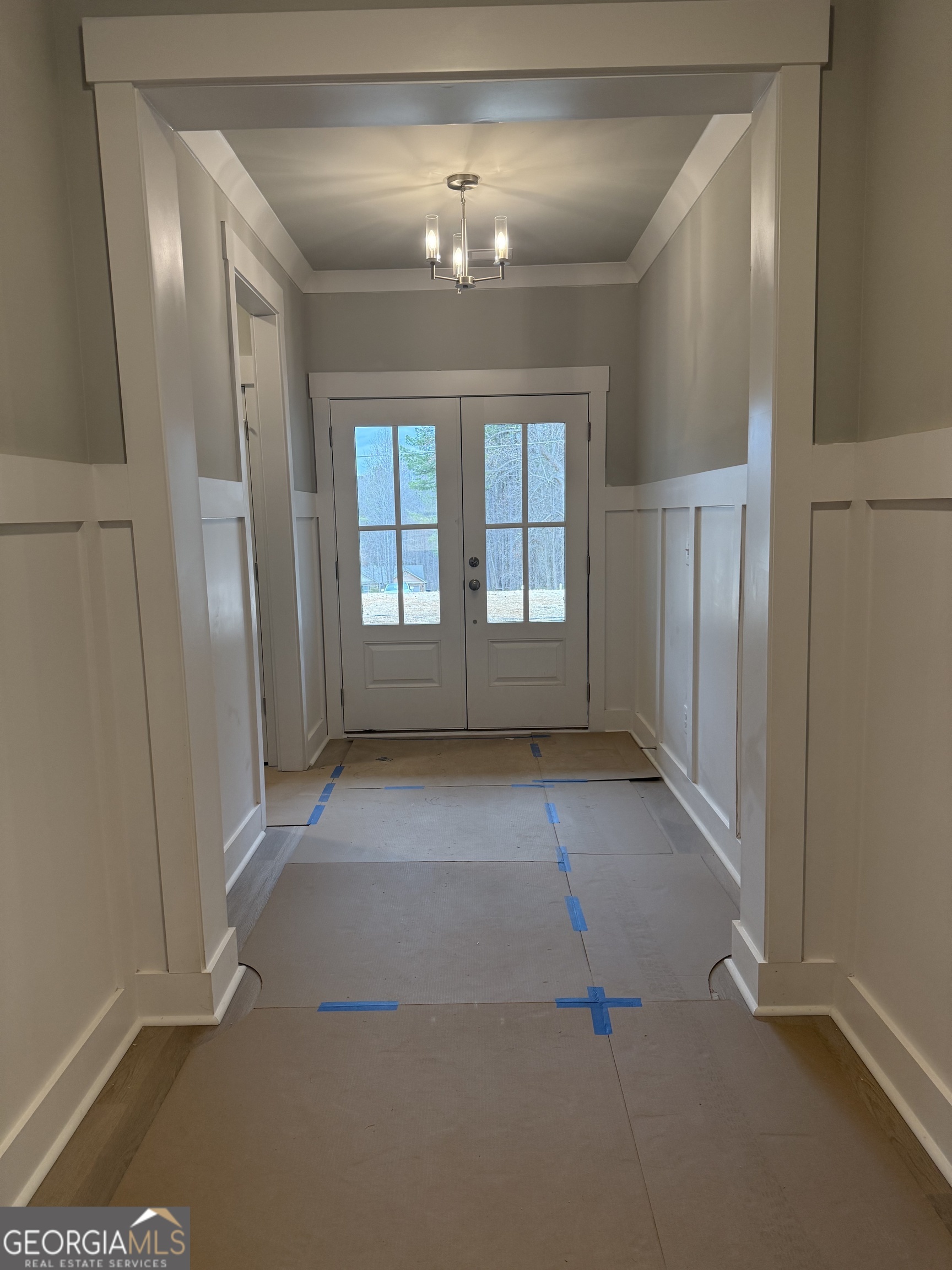 404 Tanners Bridge Road Bethlehem, GA 30620 - Photo 2 of 9 an empty room with chandelier fan and windows