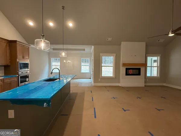 a view of a room with a fireplace cabinet and windows