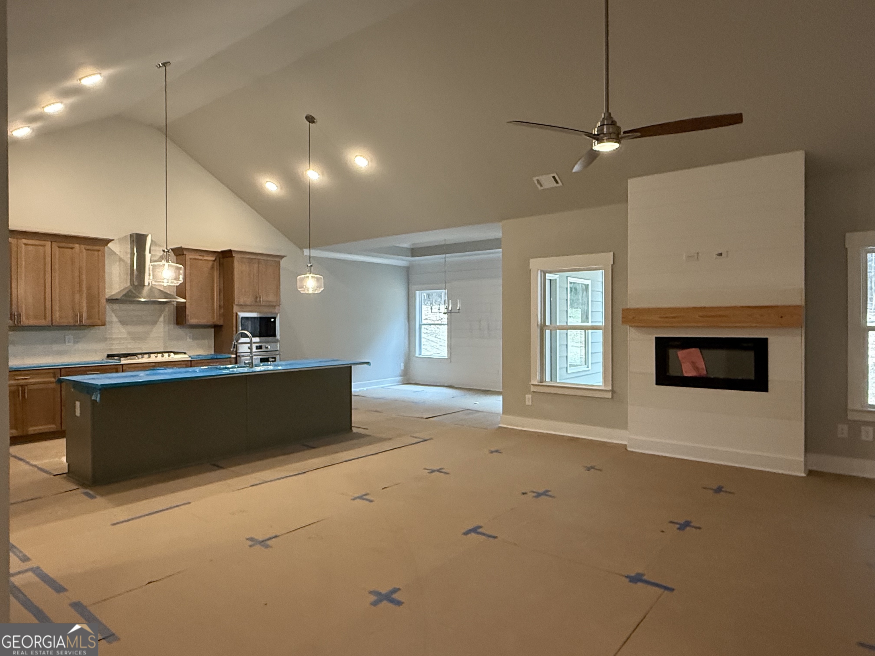 404 Tanners Bridge Road Bethlehem, GA 30620 - Photo 5 of 9 a large kitchen with kitchen island a sink stainless steel appliances and a fireplace